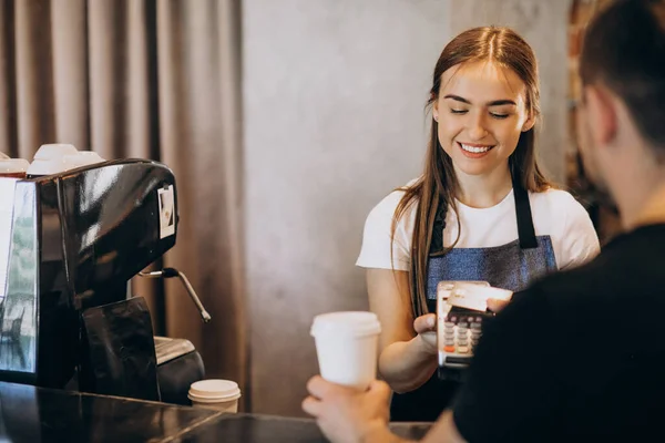 Customer paying with card in a coffee house
