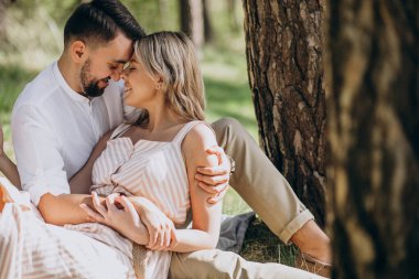 Young couple having picnic in the forest clipart