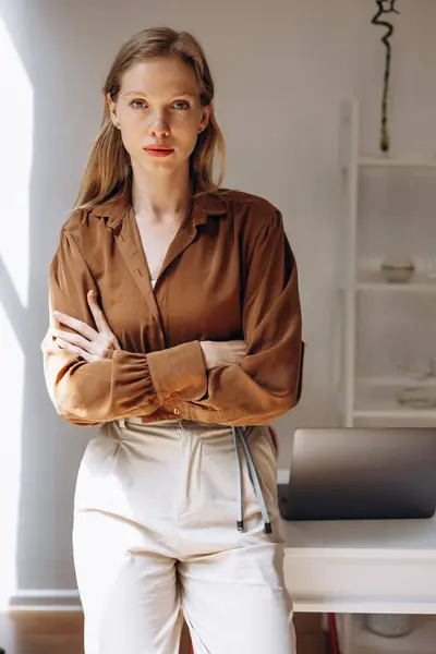 Business woman standing by the desk at her home office