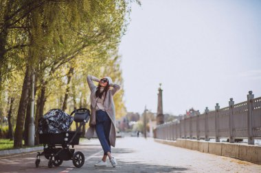 genç anne ile bebek arabası Park yürüme