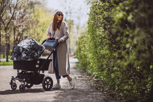 genç anne ile bebek arabası Park yürüme