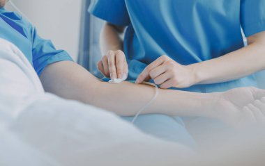 Asyalı kadın doktorlar hastanın elini tutarlar ve hasta sağlığını kontrol ederken ona tıbbi tavsiyelerde bulunurlar. Bakım ve şefkat kavramı, doğum öncesi bakım, kürtaj tehdidi