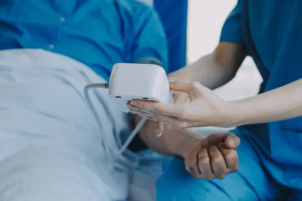 stock image Women Asian doctors hold the patient hand and encourage and provide medical advice While checking the patient health in bed. Concept of Care and compassion, antenatal care, Threatened abortion