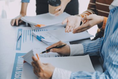 İş birliği ve başarılı ortaklık analizleri genç Asyalı iş adamlarının bir ofis çalışma alanında çalışmalarının sonucu.