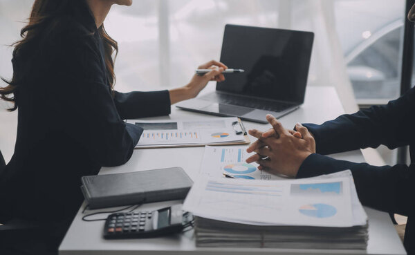 Business professionals. Group of young confident business people analyzing data using computer while spending time in the office