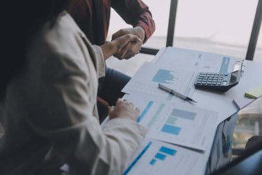 Finansal analistler, şirketlerin başarılı takım çalışmalarının sonuçlarını gösteren bir toplantıda bir dijital tablet planlama yatırım projesinin ticari mali raporlarını analiz ediyorlar..