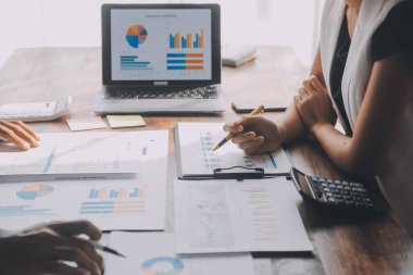 Close up of Business team analyzing income charts and graphs with modern laptop computer. Business analysis and strategy concept.