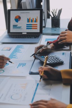 Finansal analistler, şirketlerin başarılı takım çalışmalarının sonuçlarını gösteren bir toplantıda bir dijital tablet planlama yatırım projesinin ticari mali raporlarını analiz ediyorlar..