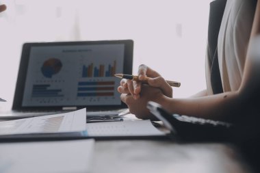 Close up of Business team analyzing income charts and graphs with modern laptop computer. Business analysis and strategy concept.