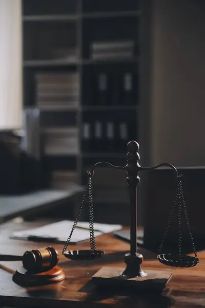image of judge\'s hammer, scales lady of justice, law book, laptop computer and contract documents with pen concept of law and justice.