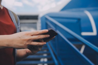 Sarışın kadın turist gelen bildirim netbook ile uçak koltuğunda oturan Smartphone cep telefonu ile kontrol. Genç işkadını paylaşmak medya telefonu dizüstü bilgisayar üzerinde uçak uçuş sırasında