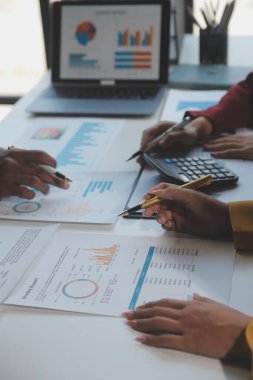 Finansal analistler, şirketlerin başarılı takım çalışmalarının sonuçlarını gösteren bir toplantıda bir dijital tablet planlama yatırım projesinin ticari mali raporlarını analiz ediyorlar..