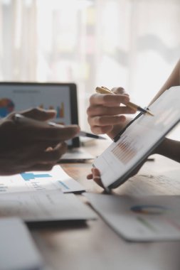 Close up of Business team analyzing income charts and graphs with modern laptop computer. Business analysis and strategy concept.