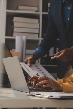 Close up of Business team analyzing income charts and graphs with modern laptop computer. Business analysis and strategy concept.