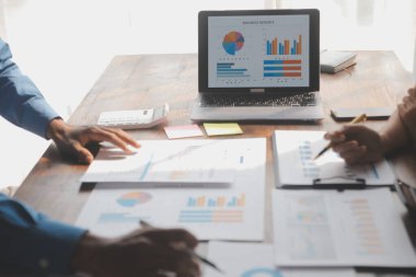 Modern dizüstü bilgisayarla gelir tabloları ve grafiklerini analiz eden iş ekibini kapatın. İş analizi ve strateji kavramı.