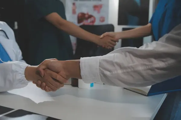 stock image Doctor handshake and partnership in healthcare, medicine or trust for collaboration, unity or support.Team of medical experts shaking hands in teamwork for or success in hospital
