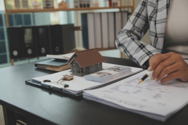 gayrimenkul kredisi satın almak veya satmak, satış temsilcisi ev satın alma sözleşmesi sunar ev veya daire ve ipotek parası ve finans kavramları satın almak için