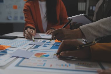 İş ekibi işbirliği mali veriler ve pazarlama büyüme raporlarıyla analiz etmeyi takım halinde, şirket kârından yararlanmak için strateji planlama, sunum ve beyin fırtınası grafiği üzerinde tartışır..