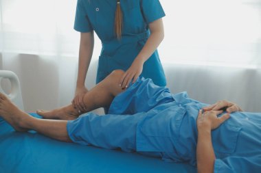 Physical therapists work with patients in close-up clinics. The concept of rehabilitation of physical health, the doctor gives advice to the patient. Ankle problems and muscle injuries