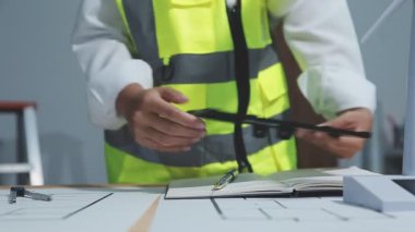 Mimar mühendisi planlar ve planlar üzerinde çalışıyor.