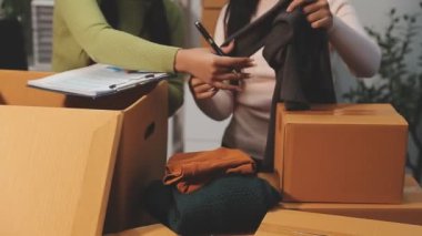 Ofisteki genç kadın, bir paket paketliyor, online teslimat.