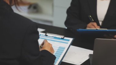 İş kadını elinde kalemle ofiste telefonla konuşuyor. iş kavramı