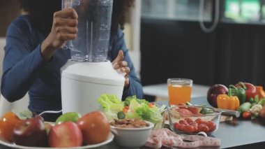 Kadın eli taze sebze suyu karıştırıyor.