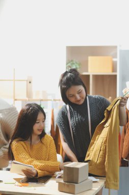 Moda tasarımcıları iş başında. Moda tasarım stüdyosunda çalışan güzel genç bir kadın..