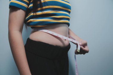 Kadın göbeği. Şişman kadın göbek yağlarını tutuyor. diyet yaşam tarzı konsepti karın kaslarını zayıflatmak ve sağlıklı mide kaslarını şekillendirmek için.