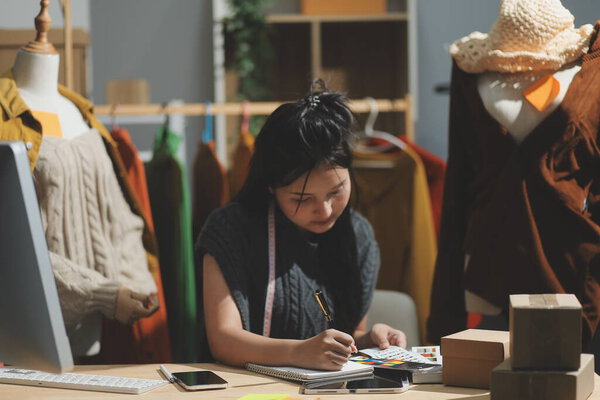 Fashion designers at work. beautiful young woman working in fashion design studio.