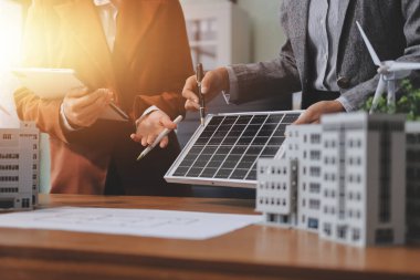 İş adamları arasında güneş pili paneli teknolojisi ve Güneş Enerjisi Çevre Kenti kavramındaki son gelişmeler üzerine tartışma.