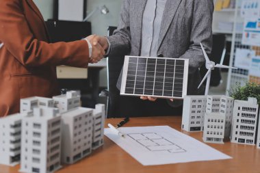 İş adamları arasında güneş pili paneli teknolojisi ve Güneş Enerjisi Çevre Kenti kavramındaki son gelişmeler üzerine tartışma.