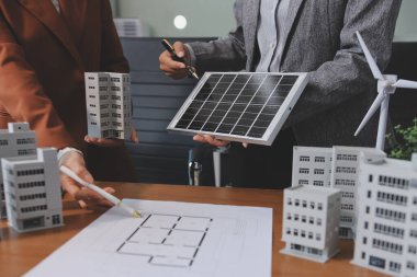 İş adamları arasında güneş pili paneli teknolojisi ve Güneş Enerjisi Çevre Kenti kavramındaki son gelişmeler üzerine tartışma.