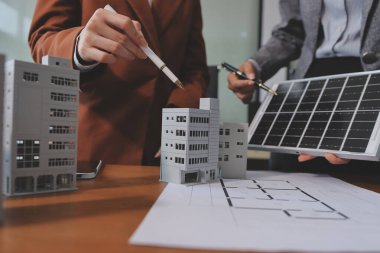 İş adamları arasında güneş pili paneli teknolojisi ve Güneş Enerjisi Çevre Kenti kavramındaki son gelişmeler üzerine tartışma.