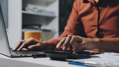 Geceleri kafede dizüstü bilgisayar kullanan bir adam.