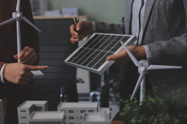 İş adamları arasında güneş pili paneli teknolojisi ve Güneş Enerjisi Çevre Kenti kavramındaki son gelişmeler üzerine tartışma.