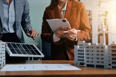 İş adamları arasında güneş pili paneli teknolojisi ve Güneş Enerjisi Çevre Kenti kavramındaki son gelişmeler üzerine tartışma.