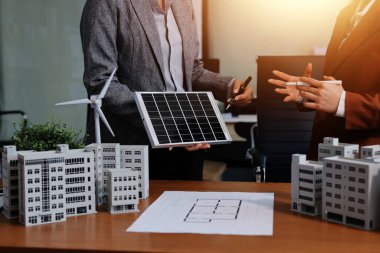 İş adamları arasında güneş pili paneli teknolojisi ve Güneş Enerjisi Çevre Kenti kavramındaki son gelişmeler üzerine tartışma.