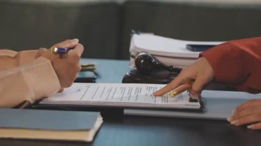 Ofisteki masada kağıda yazı yazan iş kadını.