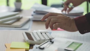 Kapat. Hesap makinesi ve mali belgeleri olan iş adamı.