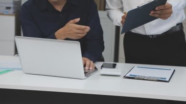 Ofiste dizüstü bilgisayar kullanan bir iş adamı.