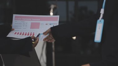 Belgeleri tutan ve tahtaya yazı yazan bir iş adamı..