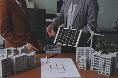 İş adamları arasında güneş pili paneli teknolojisi ve Güneş Enerjisi Çevre Kenti kavramındaki son gelişmeler üzerine tartışma.