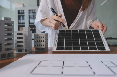 İş adamları arasında güneş pili paneli teknolojisi ve Güneş Enerjisi Çevre Kenti kavramındaki son gelişmeler üzerine tartışma.