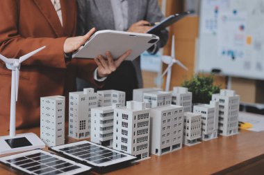 İş adamları arasında güneş pili paneli teknolojisi ve Güneş Enerjisi Çevre Kenti kavramındaki son gelişmeler üzerine tartışma.