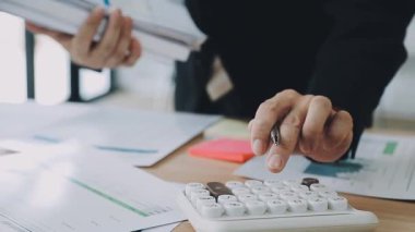 İş adamı eli hesap makinesinde.