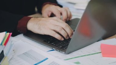 Ofiste dizüstü bilgisayar kullanan bir iş adamı