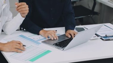 İş ekibi ofisteki masada dizüstü bilgisayarla çalışıyor..