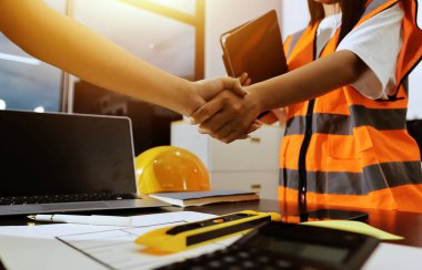 Endüstriyel mühendislerden oluşan bir ekip, fabrikadaki masada bulunan makine planlarını analiz ediyor. Fabrikada ya da üretim tesisinde çalışıyorum..