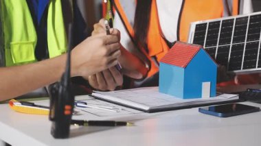 Güneş paneli ile inşaat alanında çalışan mühendis. Ev bakımı ve mühendisi evde çalışıyor..